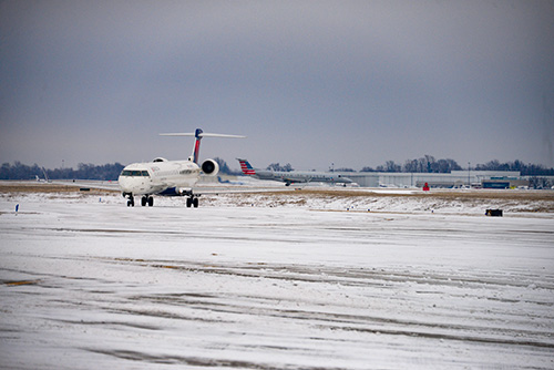 Image of two planes in snow at the airport