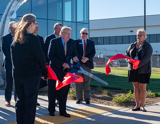 Group of people cut the ceremonial ribbon